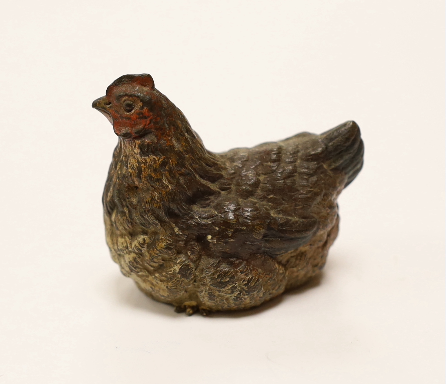 A large Austrian cold painted bronze model of a hen sitting, 5cm high